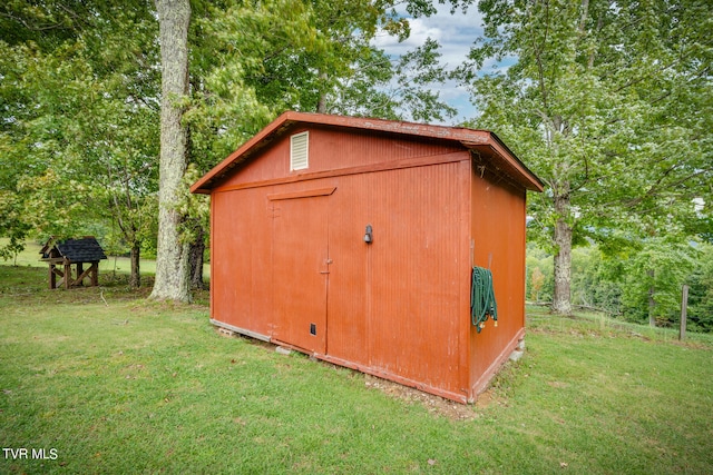 view of outdoor structure with a lawn