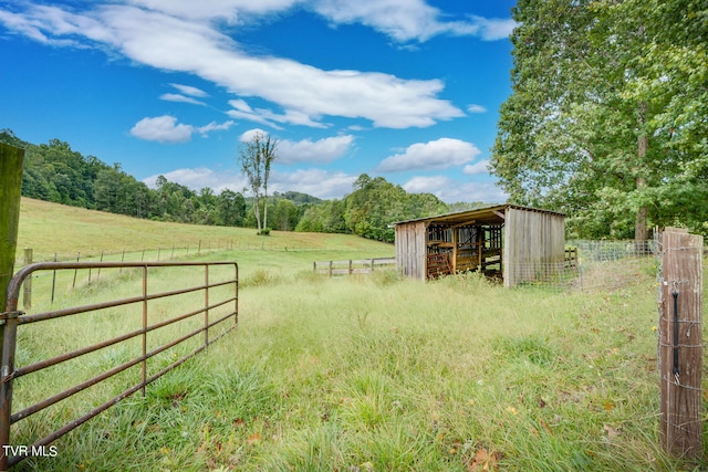 view of yard with an outbuilding and a rural view