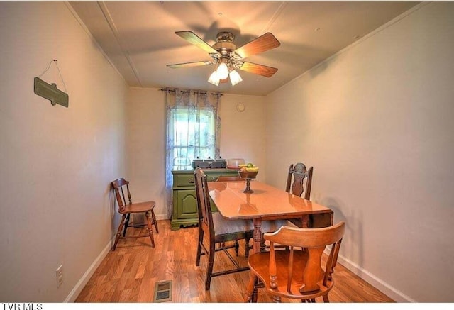 dining area with crown molding, light hardwood / wood-style floors, and ceiling fan