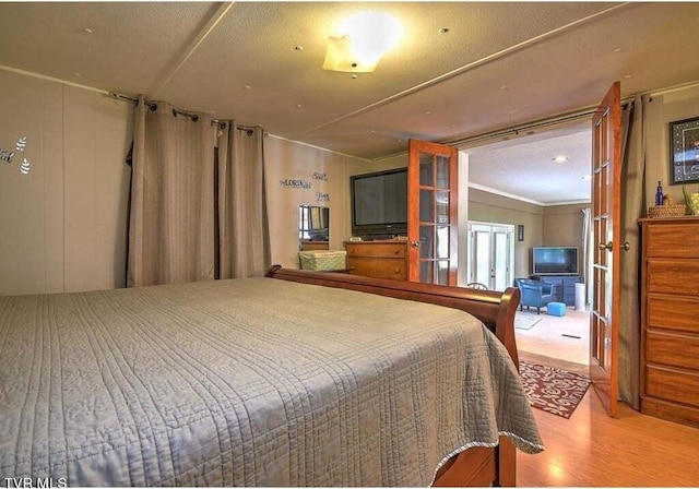 bedroom with a textured ceiling and hardwood / wood-style floors