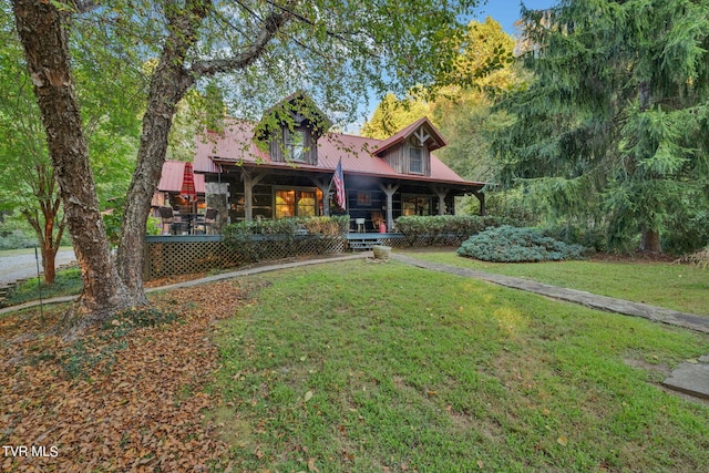 rear view of property featuring a lawn and a wooden deck