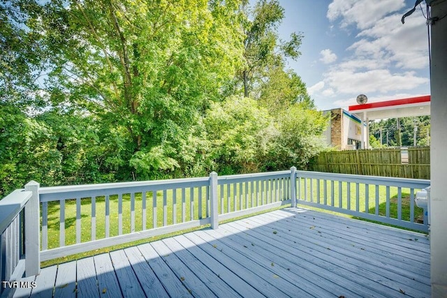 deck with a lawn and fence