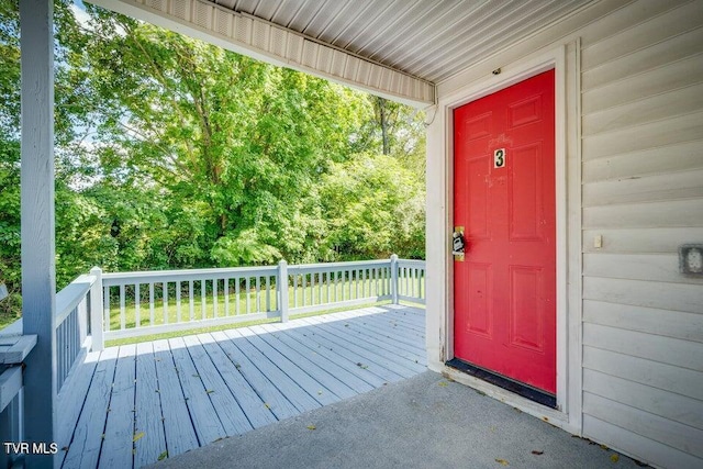 view of exterior entry featuring a deck