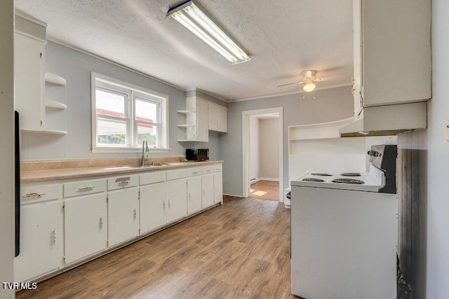 kitchen with open shelves, ceiling fan, light wood-style flooring, electric stove, and a sink