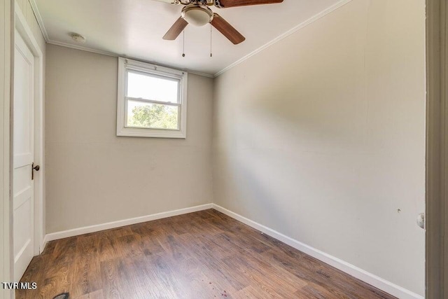 empty room with ornamental molding, a ceiling fan, baseboards, and wood finished floors