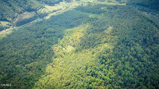 birds eye view of property featuring a view of trees