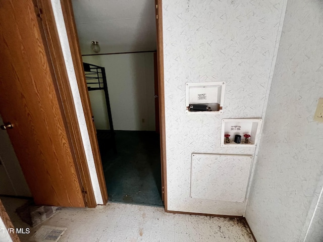 laundry area featuring visible vents, a textured wall, laundry area, hookup for a washing machine, and light floors