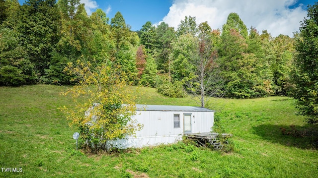 view of storm shelter with a yard
