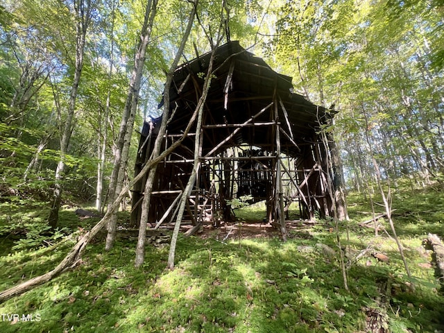 view of outbuilding featuring a wooded view
