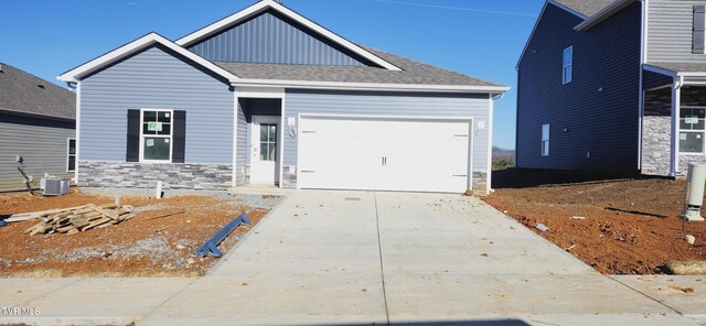 craftsman inspired home with a garage and central AC