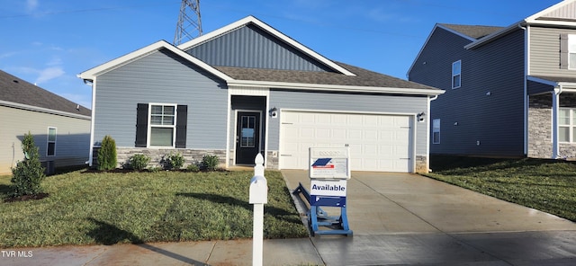 view of front of house with a garage and a front lawn