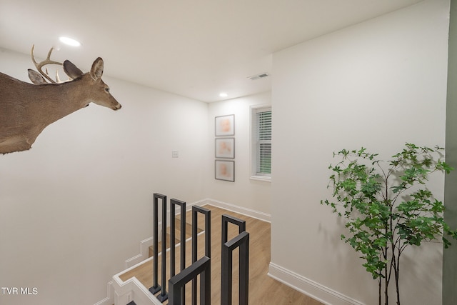 stairway featuring hardwood / wood-style flooring