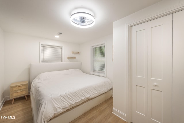 bedroom with light wood-type flooring and a closet