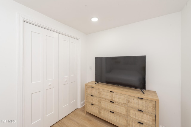 bedroom featuring hardwood / wood-style floors and a closet