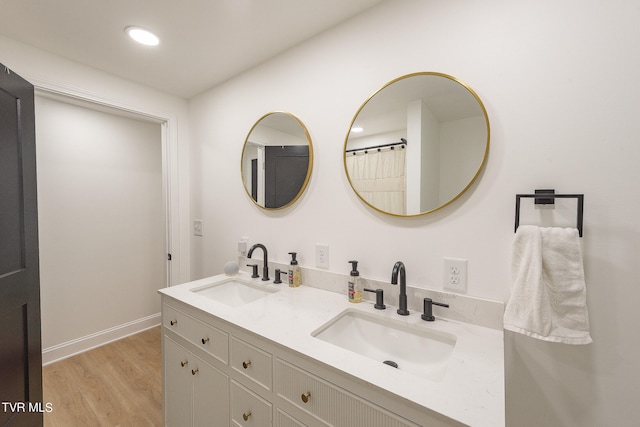 bathroom with vanity and wood-type flooring