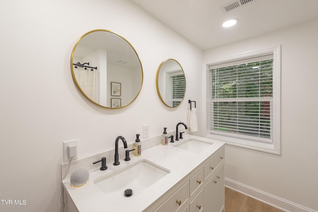 bathroom with vanity and wood-type flooring