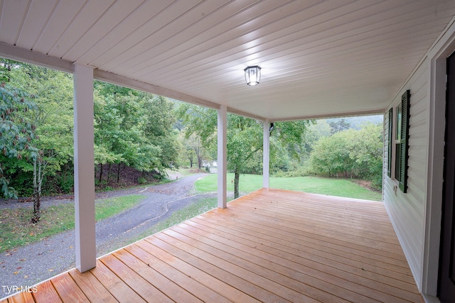 wooden deck with a lawn