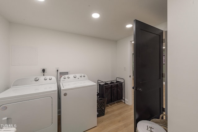 clothes washing area featuring light hardwood / wood-style flooring and independent washer and dryer