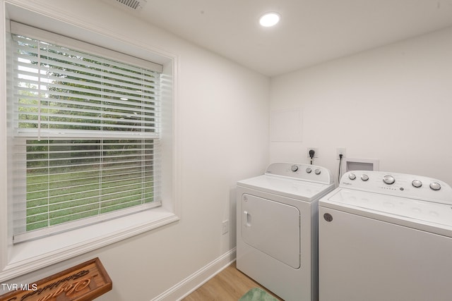 laundry area featuring light wood-type flooring and independent washer and dryer