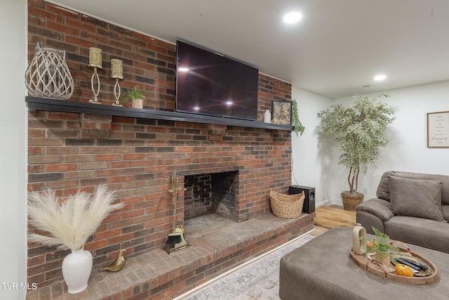 living room featuring a brick fireplace