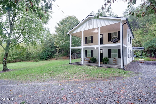 view of front of house featuring covered porch and a front yard