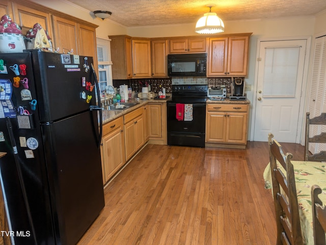 kitchen with light hardwood / wood-style flooring, backsplash, crown molding, black appliances, and a textured ceiling