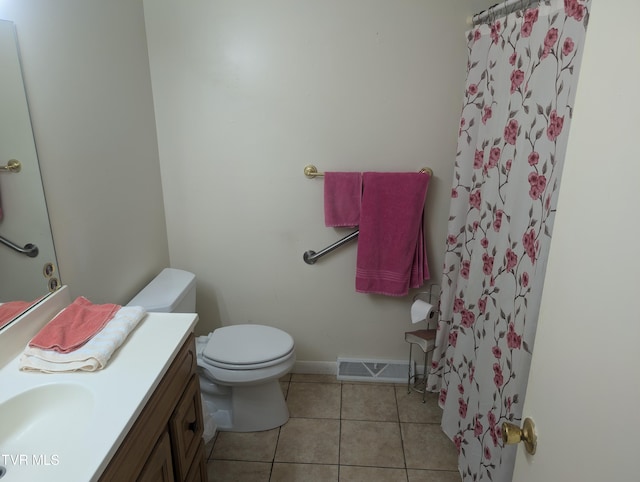 bathroom with vanity, a shower with curtain, toilet, and tile patterned floors