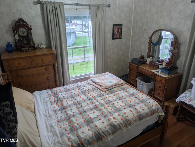 bedroom featuring multiple windows and wood-type flooring