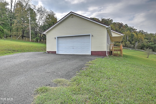 garage featuring a lawn