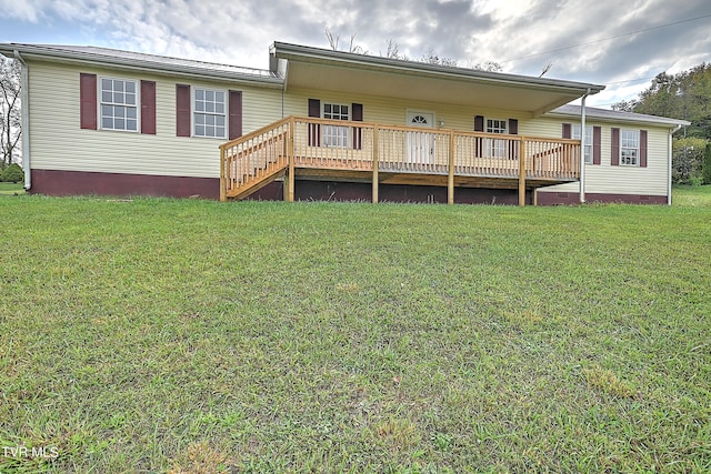 rear view of property with a deck and a yard