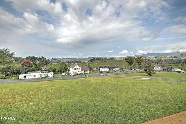 exterior space with a yard and a mountain view