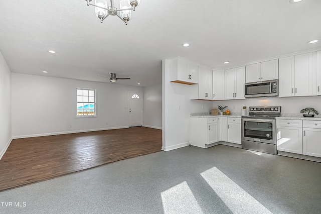 kitchen featuring ceiling fan with notable chandelier, white cabinets, stainless steel appliances, and dark hardwood / wood-style flooring