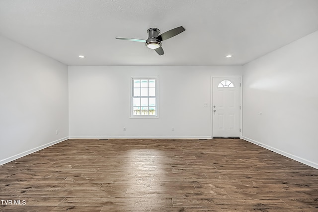 foyer with ceiling fan and dark wood-type flooring