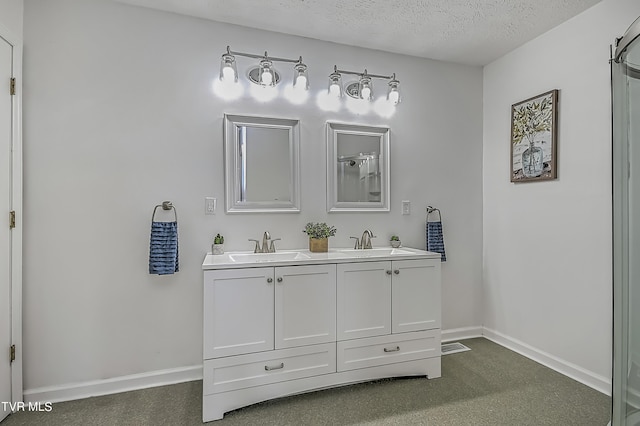 bathroom featuring a textured ceiling and vanity