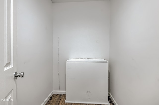 laundry area featuring dark wood-type flooring