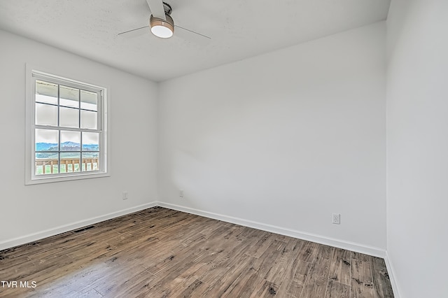 spare room with ceiling fan and hardwood / wood-style floors