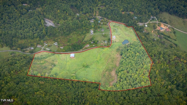 drone / aerial view featuring a wooded view