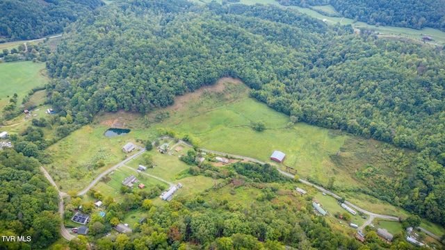 drone / aerial view with a wooded view