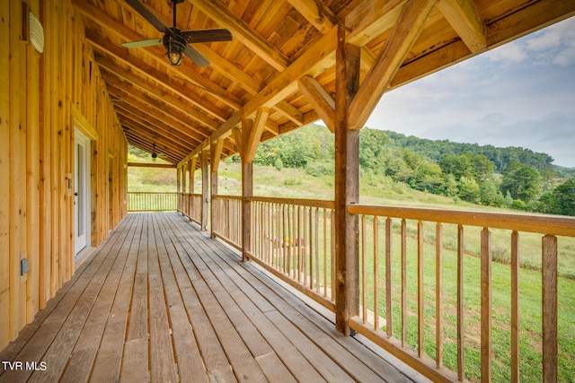 deck featuring a yard and ceiling fan