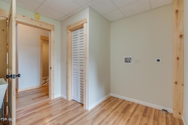 washroom featuring electric dryer hookup, hookup for a washing machine, baseboards, and light wood finished floors