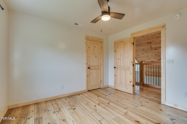 empty room featuring ceiling fan and light hardwood / wood-style flooring