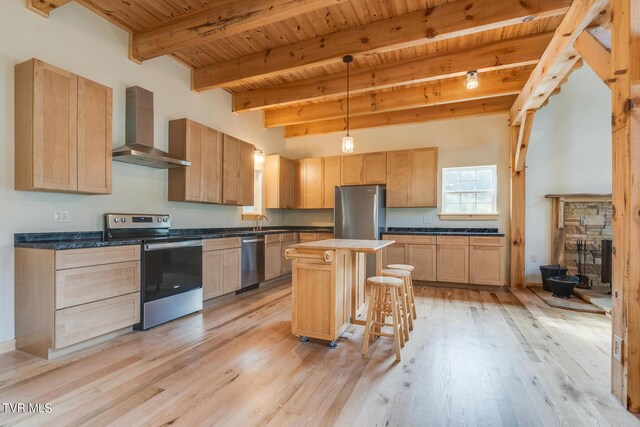 kitchen with wall chimney range hood, wooden ceiling, appliances with stainless steel finishes, and light wood-style floors