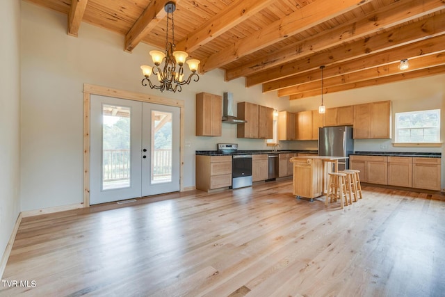 kitchen with french doors, wood ceiling, dark countertops, wall chimney range hood, and appliances with stainless steel finishes