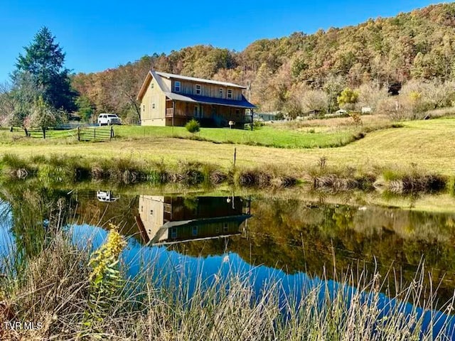 dock area with a lawn and a water view