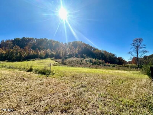 mountain view featuring a rural view