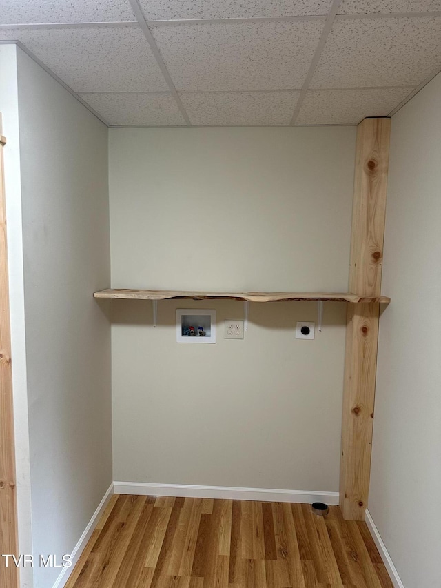 clothes washing area featuring light wood finished floors, washer hookup, baseboards, laundry area, and electric dryer hookup