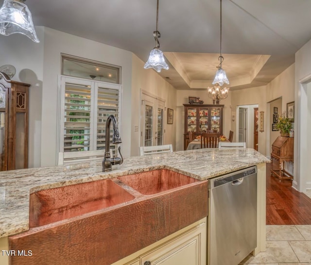 kitchen with french doors, stainless steel dishwasher, a raised ceiling, light hardwood / wood-style floors, and hanging light fixtures