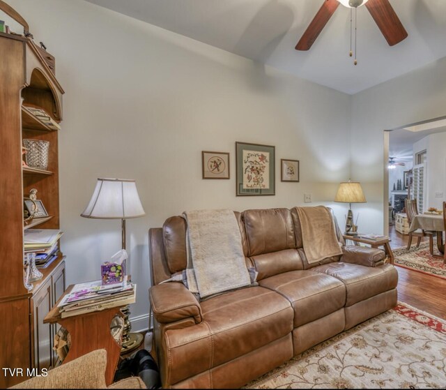 living room featuring hardwood / wood-style flooring and ceiling fan