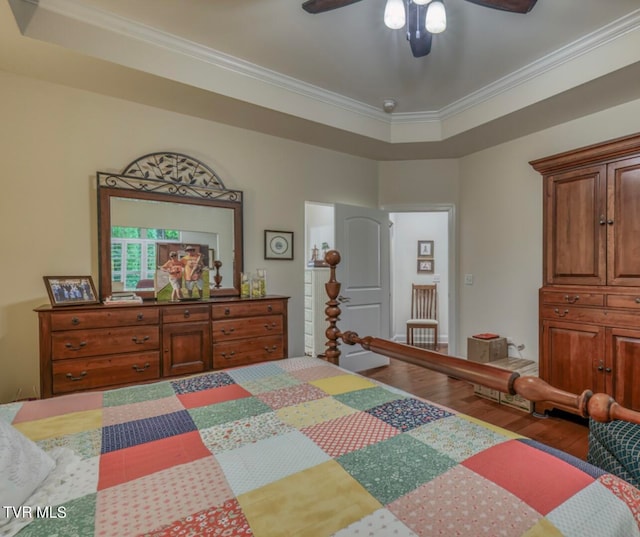 bedroom featuring ceiling fan, dark hardwood / wood-style flooring, and ornamental molding