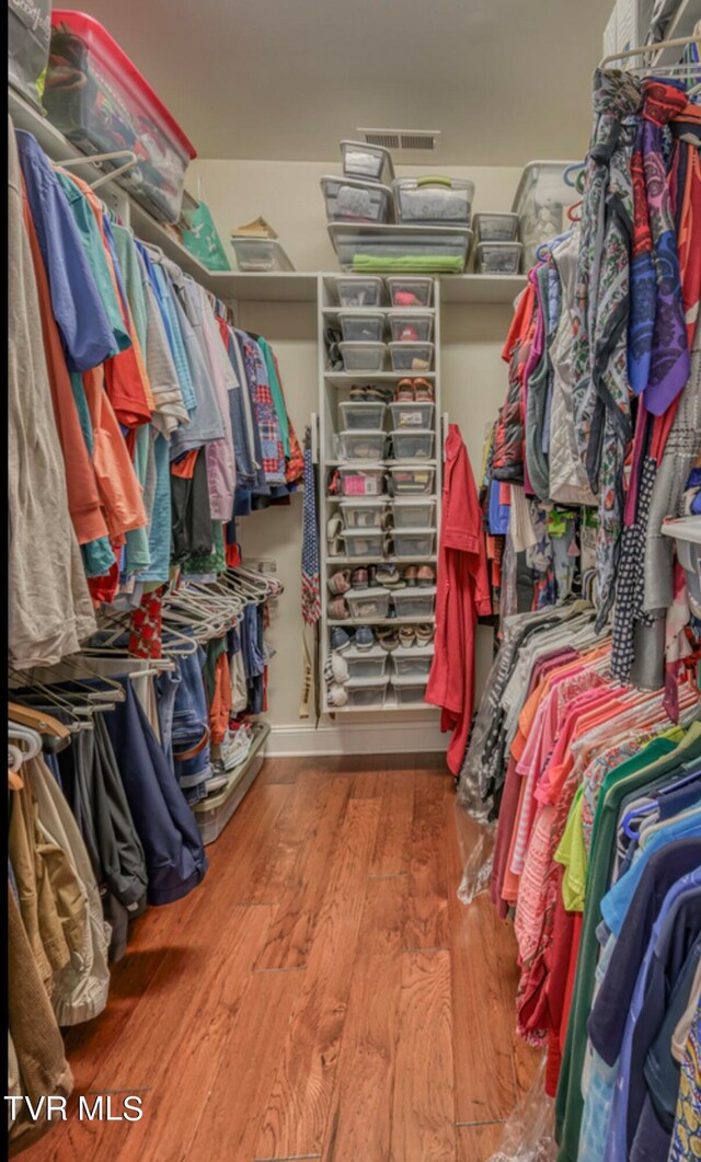 walk in closet featuring hardwood / wood-style flooring